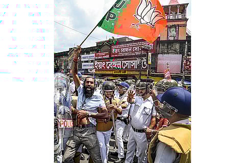BJP's Bengal Bandh: Police personnel detain a BJP worker during party's 12-hour general strike Kolkata